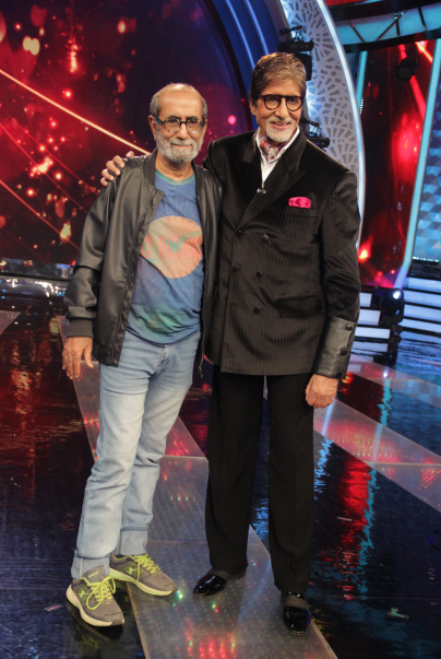 Aabid Surti and Amitabh Bachchan standing together on a brightly lit TV studio stage.