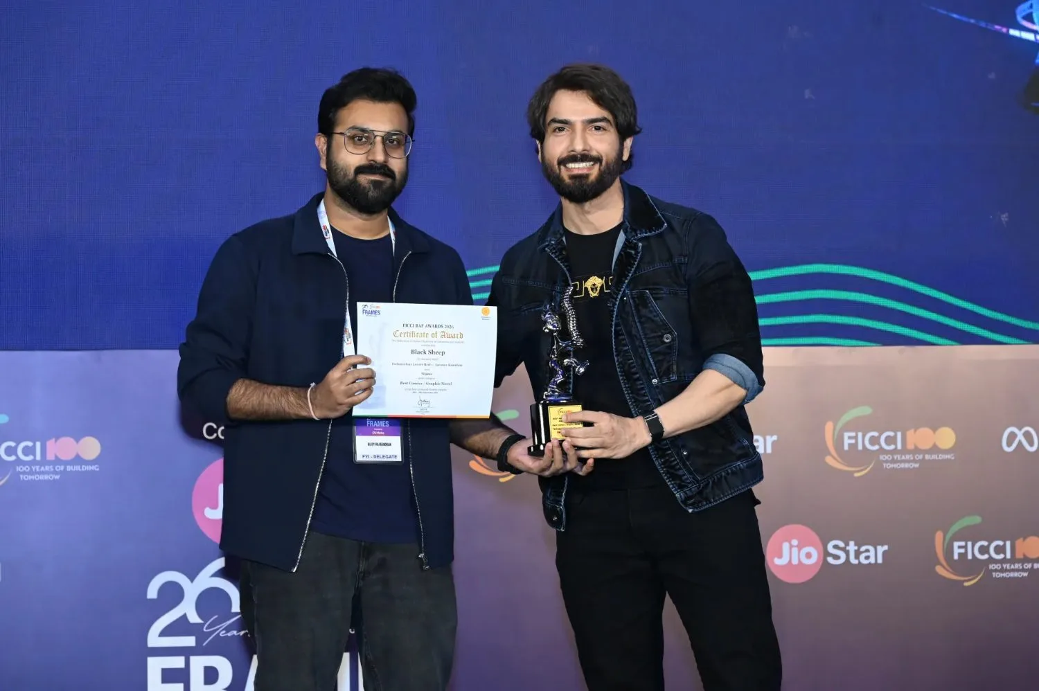 Bijoy Raveendran holds the Best Comics trophy and certificate beside Niraj Ruparel at the FICCI BAF Awards 2026.